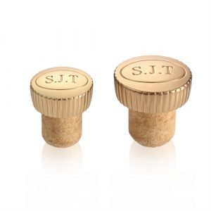 Zamak bottle stoppers in gold-tone and embossed logos Gold coloured zamak bottle stoppers embossed with special branding and with fluted edges
