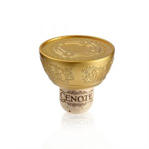 Yellow gold zamak bottle stopper with branding to top & edge Zamak bottle stopper in yellow gold finish and embossed branding to top & edges